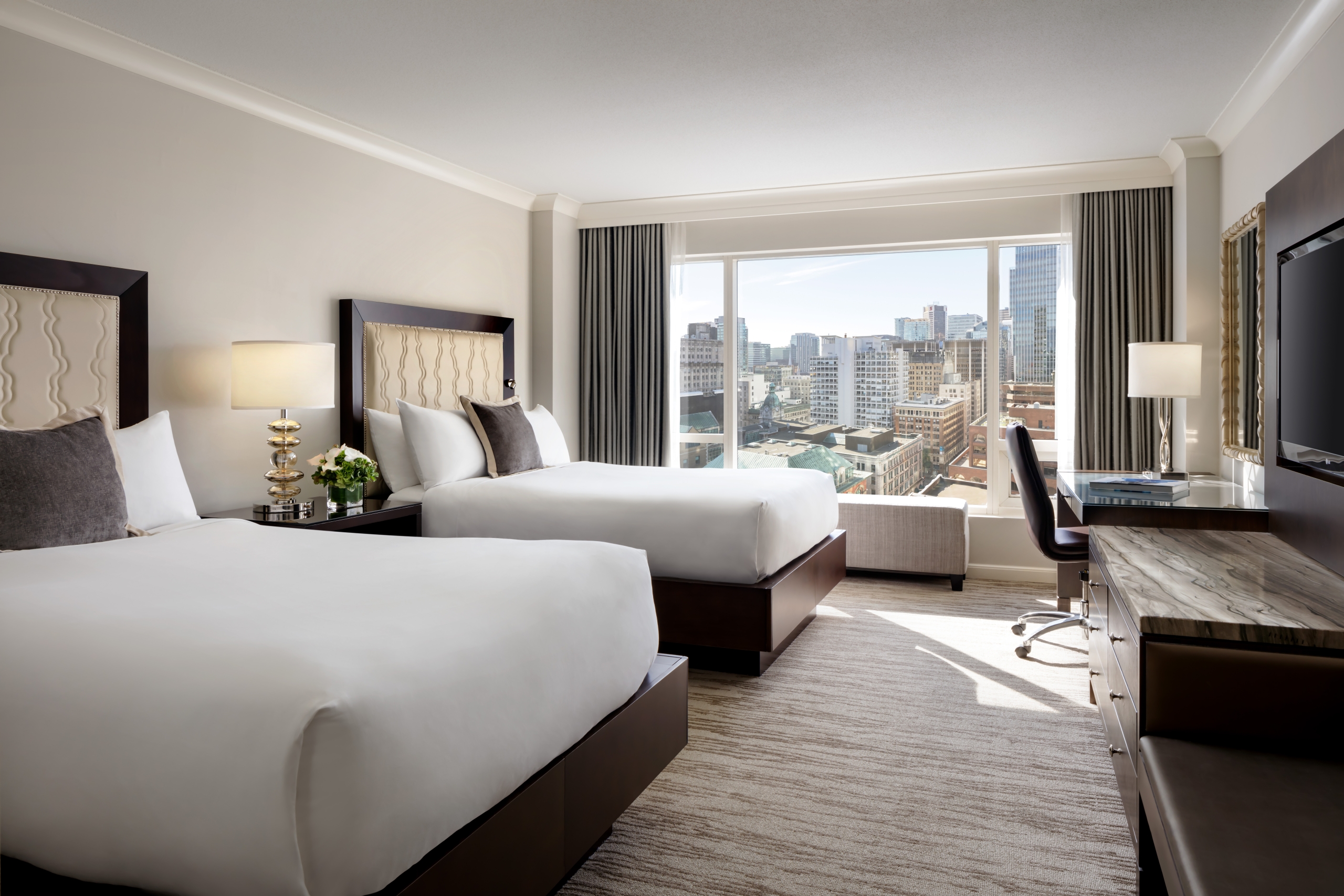 image of two beds and city skyline view from Deluxe City View Room