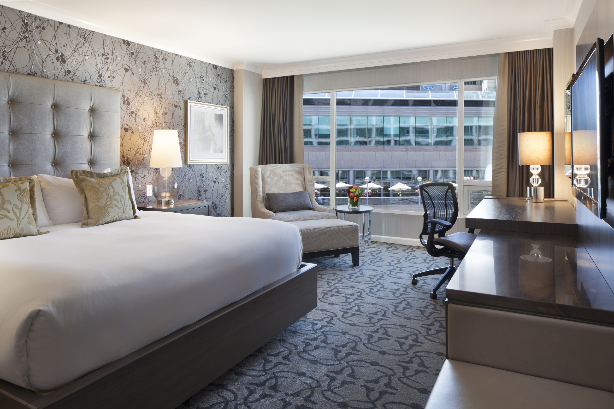 view of bedroom with view of city from Fairmont Gold city-view guestroom