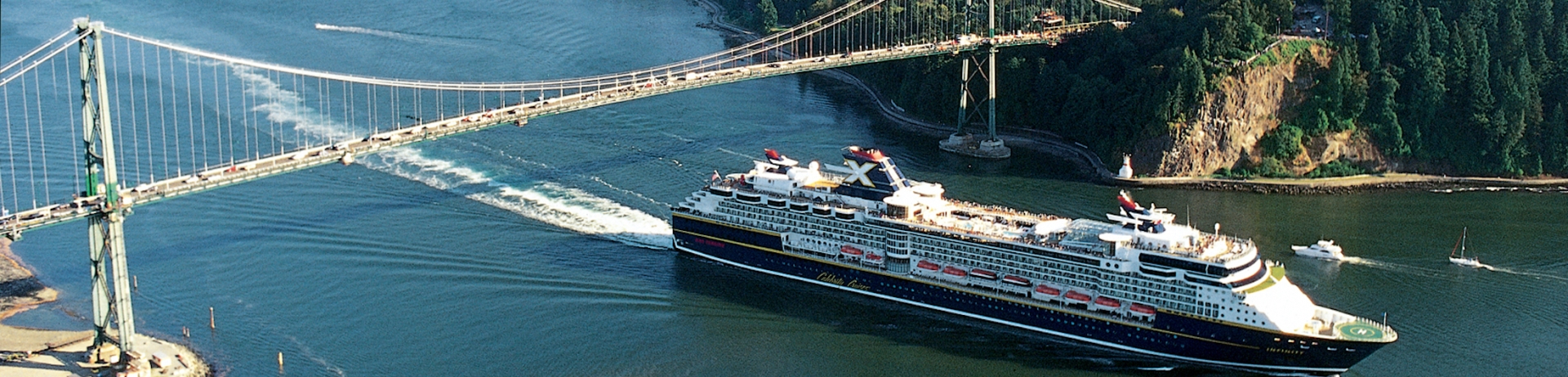 a view of a cruise ship under the lions gate bridge
