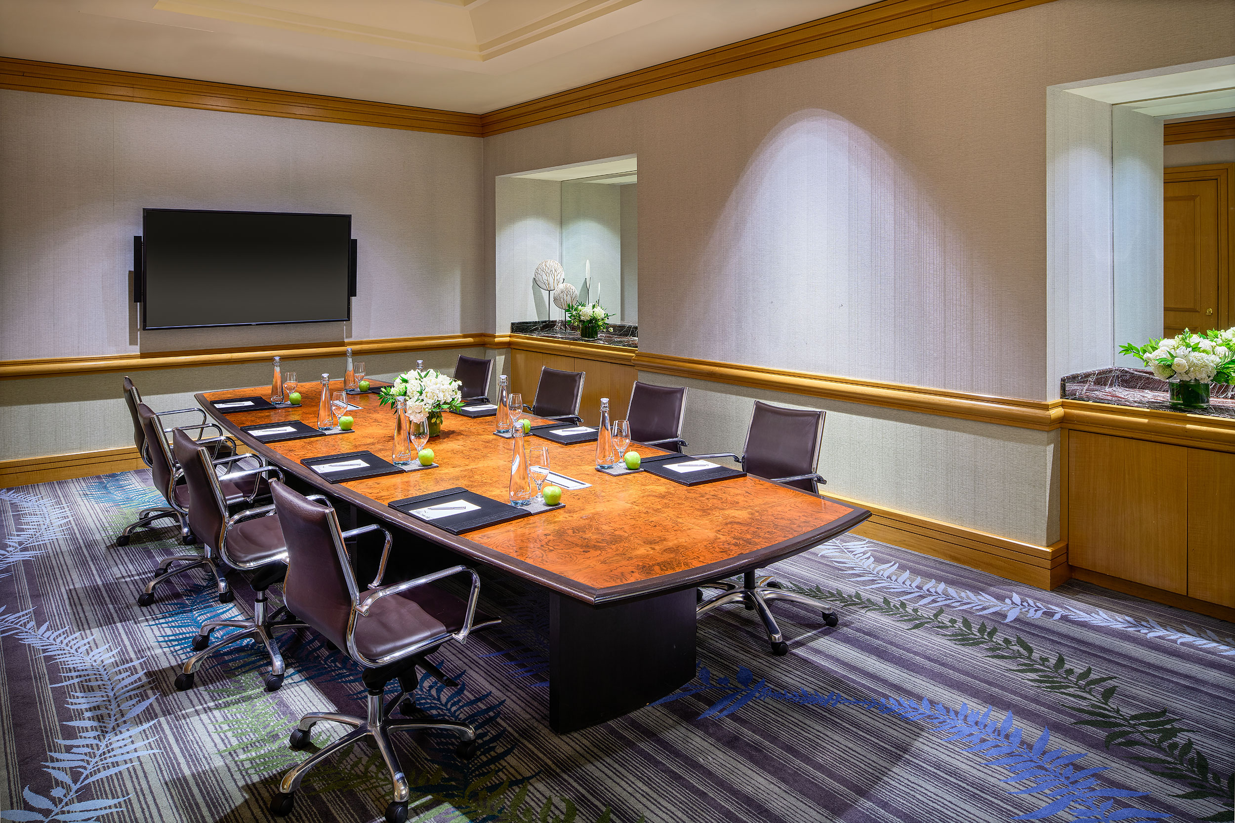 dimly lit boardroom table in Fairmont Waterfront's Douglas Boardroom