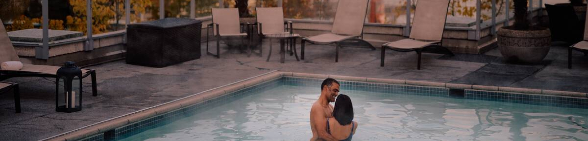 Couple embracing in rooftop pool at Fairmont Waterfront