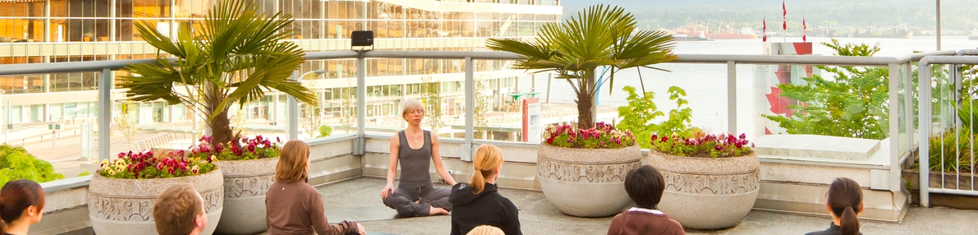 a group of people doing yoga on a pool deck at Fairmont Waterfront