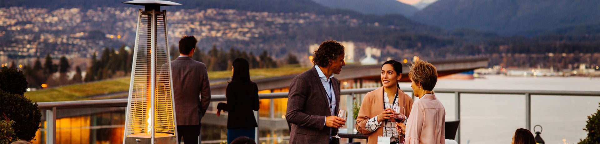 Group of people enjoying cocktails and the harbour-view at Fairmont Waterfront.