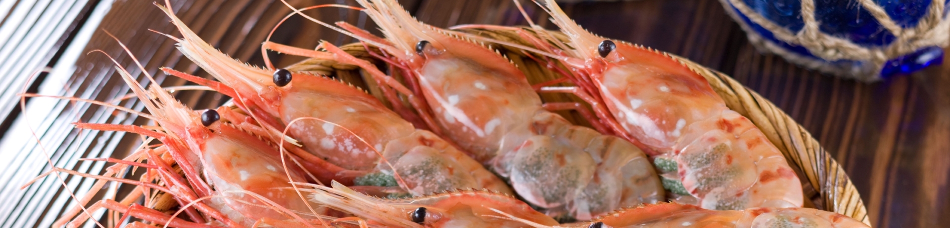A dish of spot prawns sitting on a table