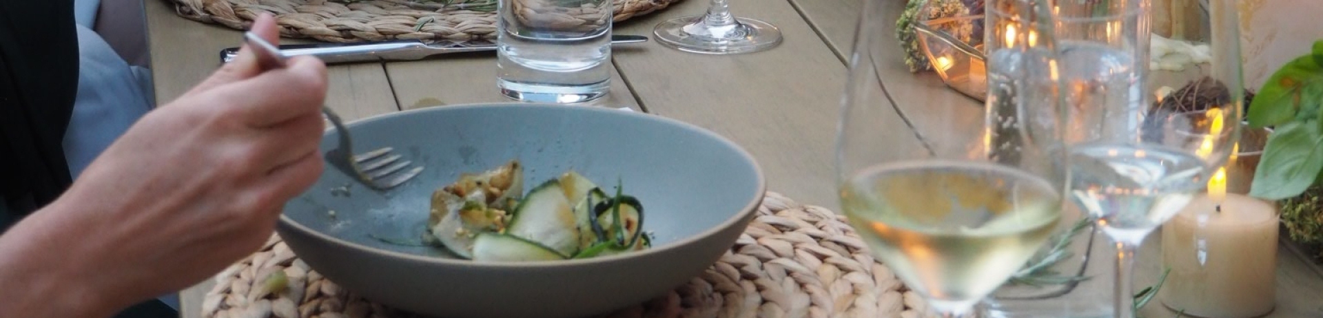 Close-up of garden dinner series table with floralsand dishes.