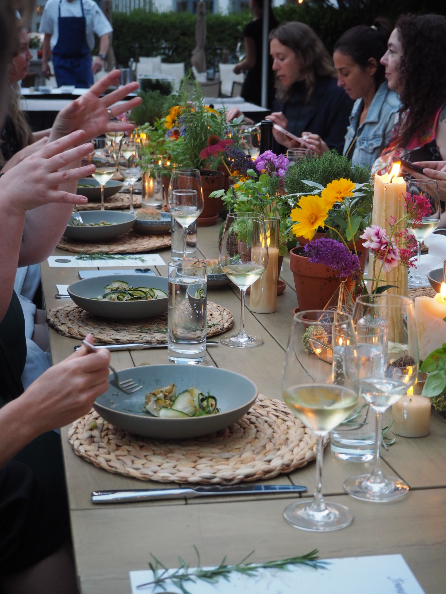 Close-up of garden dinner series table with floralsand dishes.