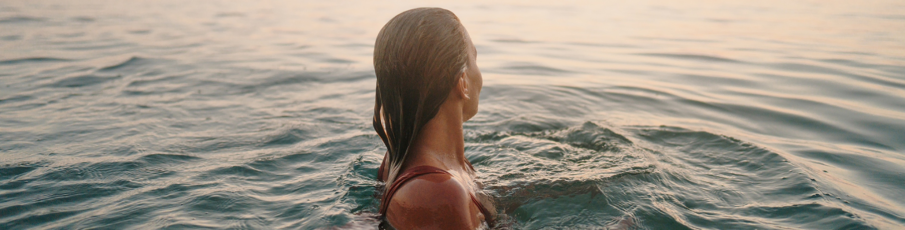 Woman looking away from camera while swimming in the ocean