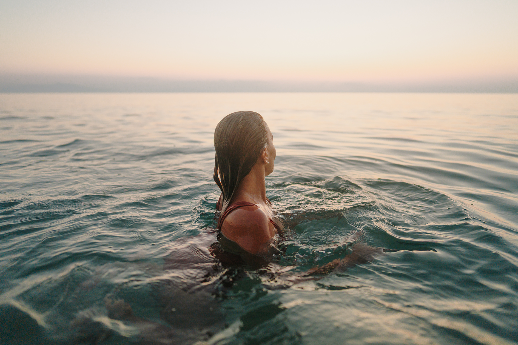 Woman looking away from camera while swimming in the ocean