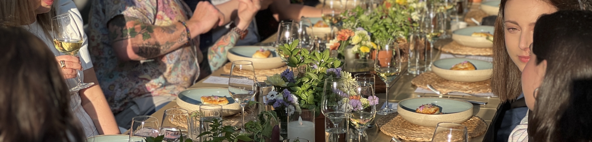A group of people dining in Fairmont Waterfront's rooftop garden