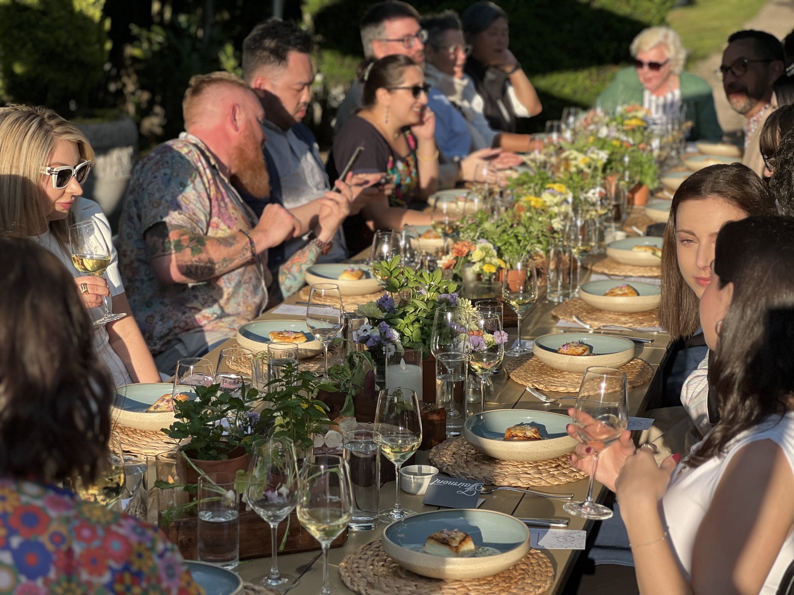 A group of people dining in Fairmont Waterfront's rooftop garden