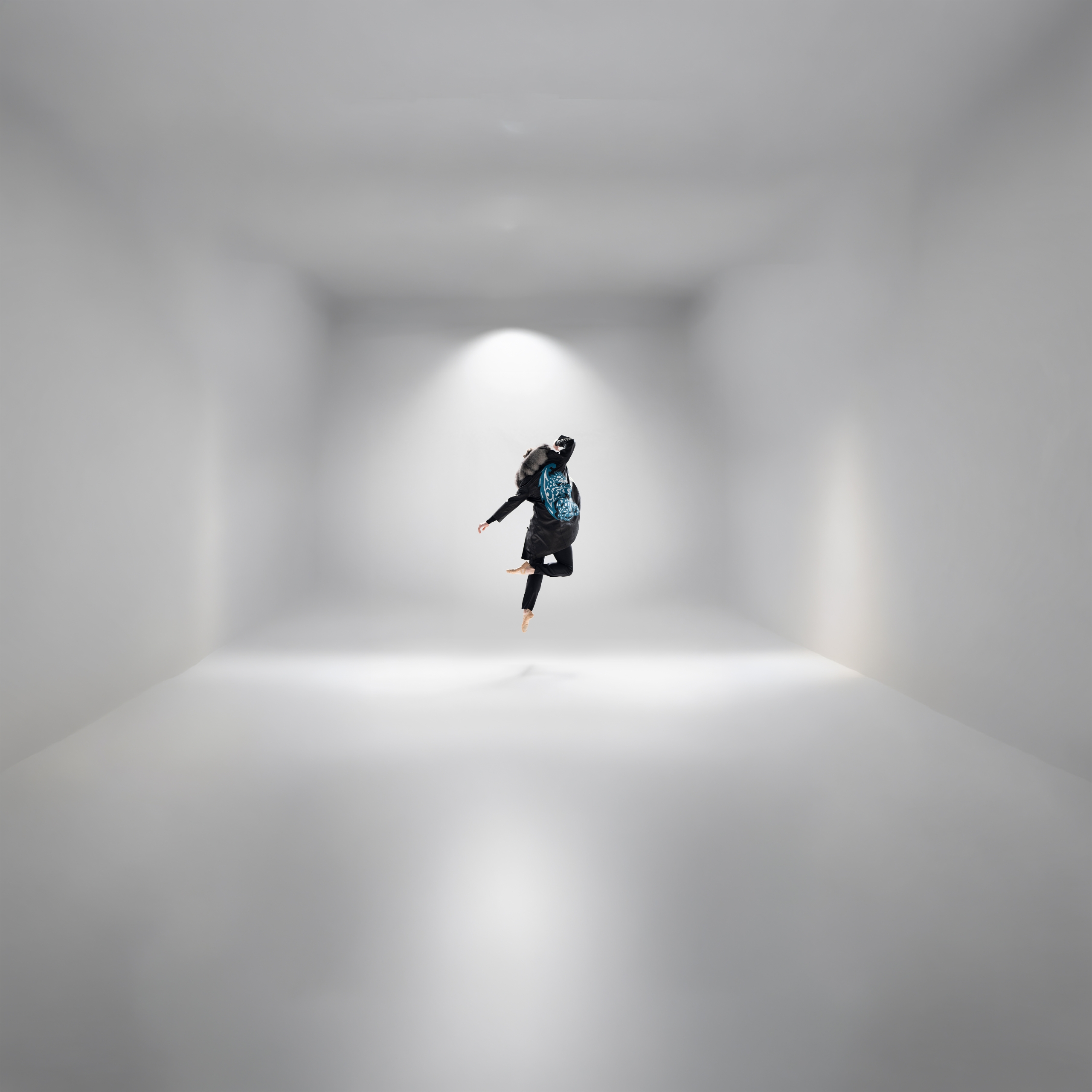 A ballet dancer in mid-air pose highlighting the Indigenous designs of Yolanda Skelton.