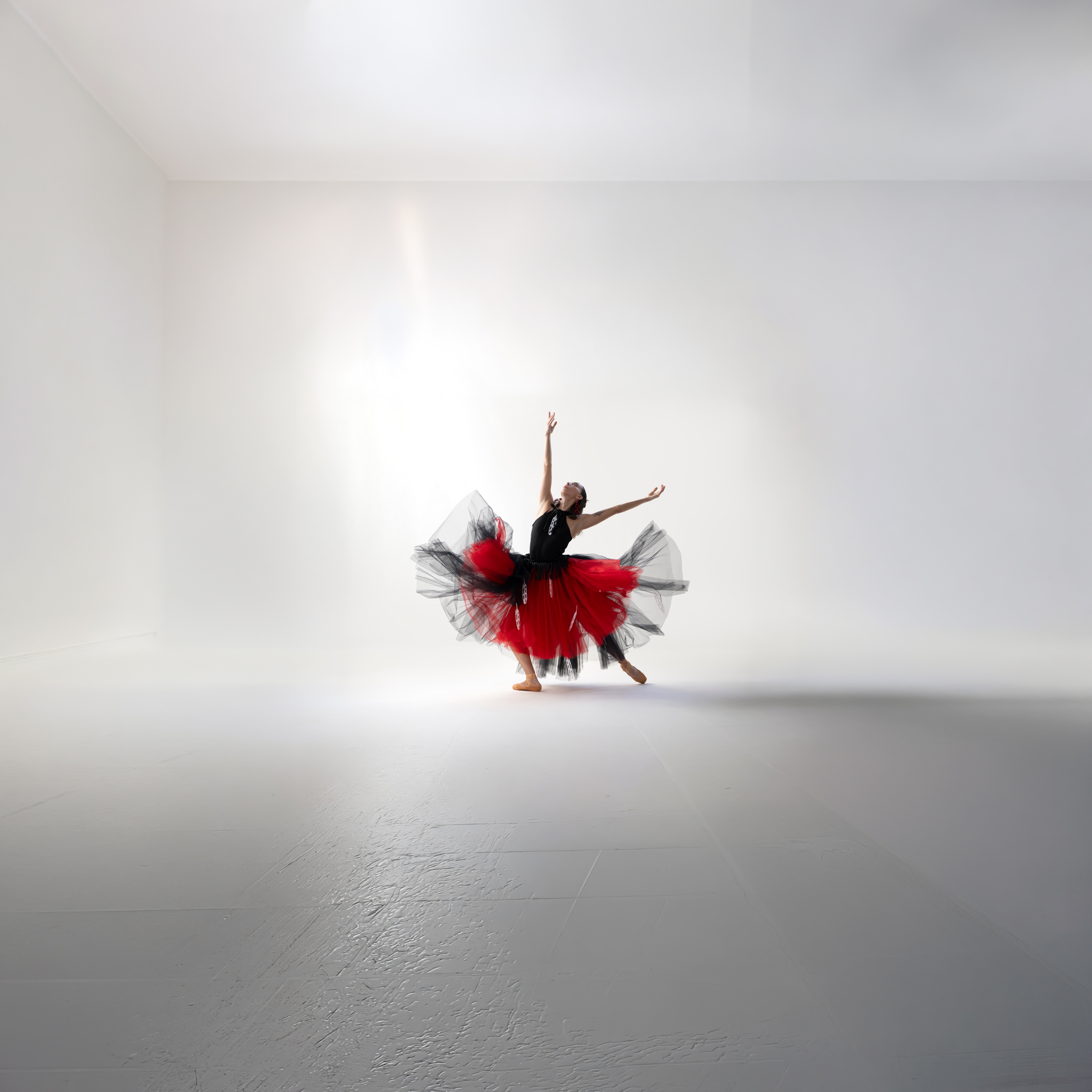 A ballet dancer in mid-air pose highlighting the Indigenous designs of Yolanda Skelton.