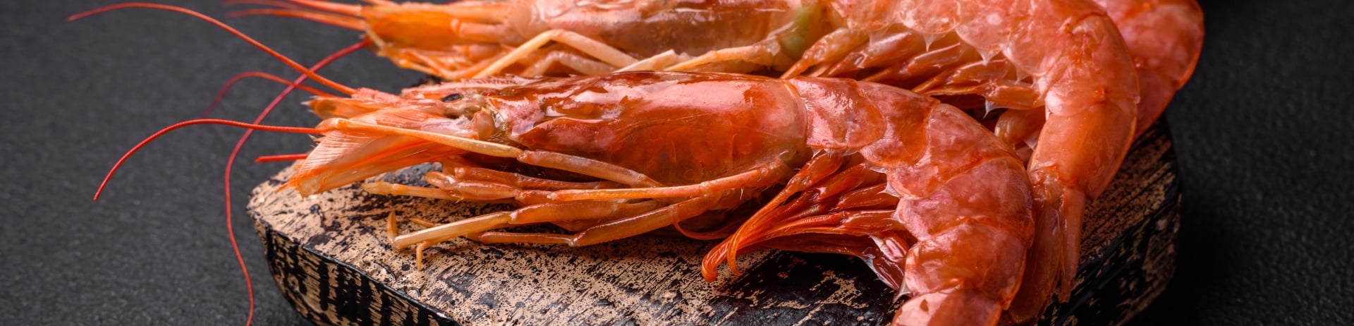 board with spot prawns laying on it