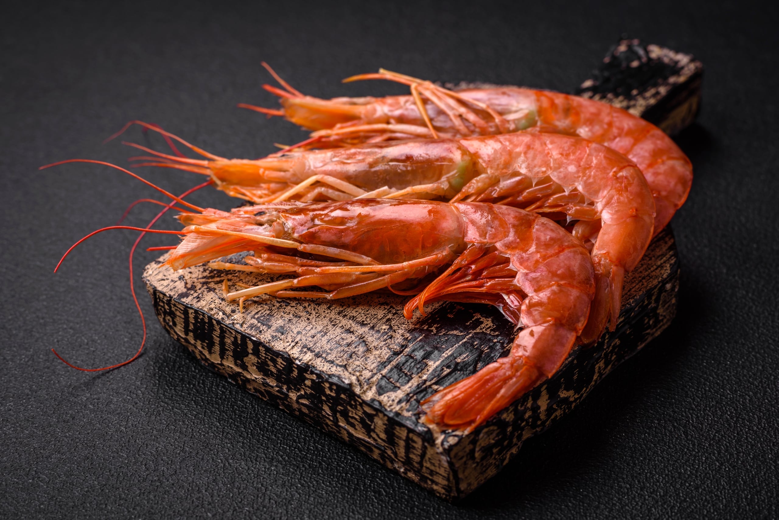board with spot prawns laying on it